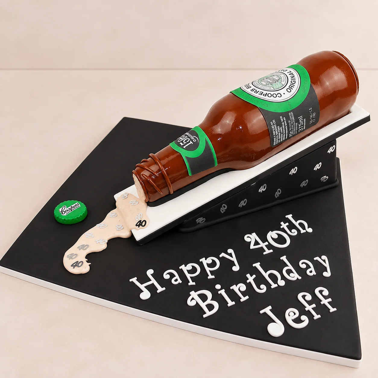 Beer bottle shaped 40th birthday cake on a black board