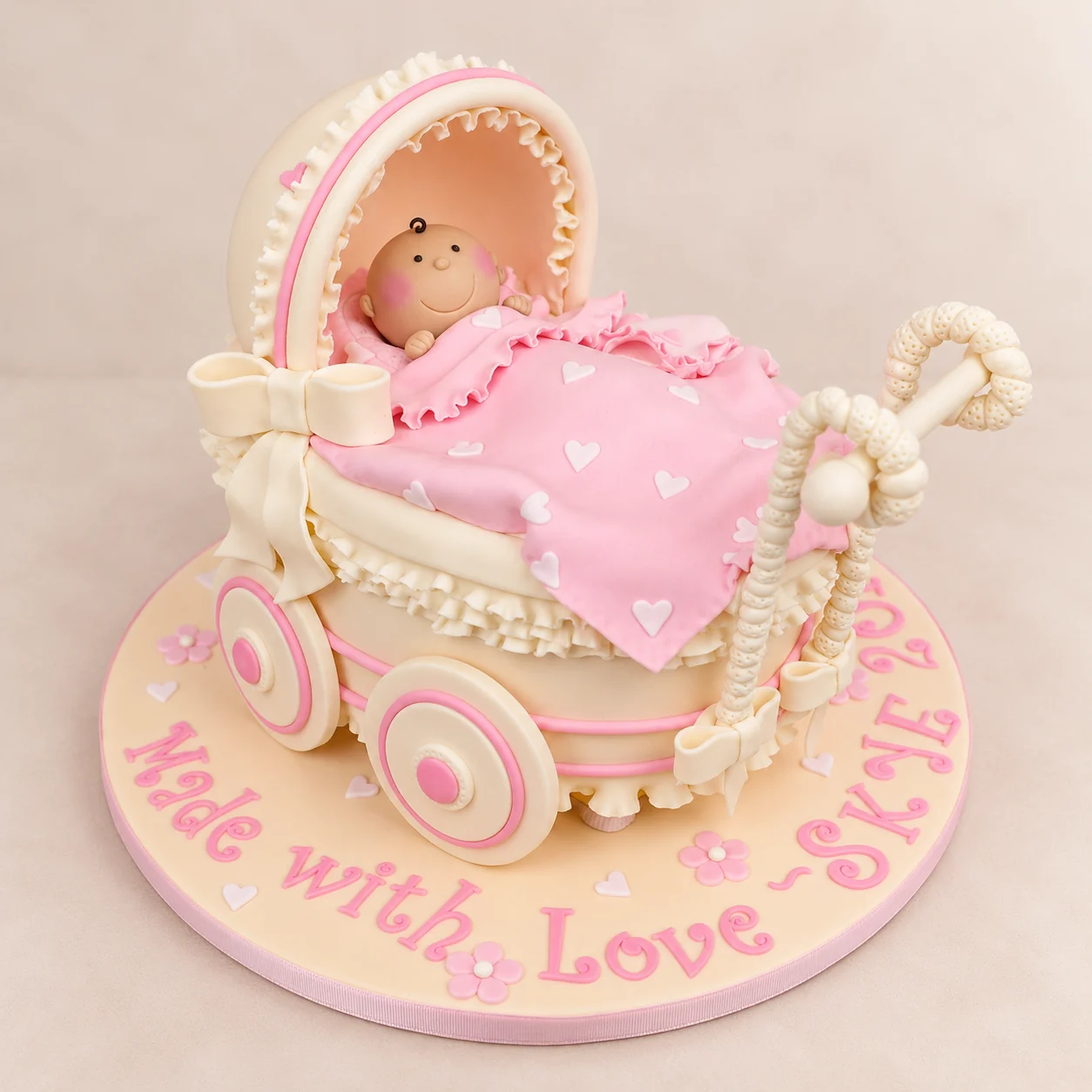 Pink baby-pram baby shower cake for a baby girl